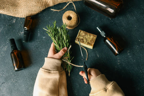 Rosemary essential oil bottle with fresh rosemary leaves